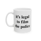 Film The Police Mug with bold black text on a plain white ceramic surface, reminding users it's legal to film police. Availab