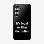 Film The Police Samsung Tough Phone Case: Back view of a smartphone showcasing a triple-lens camera and a glossy black case with “it’s legal to film the police” printed in bold white text.