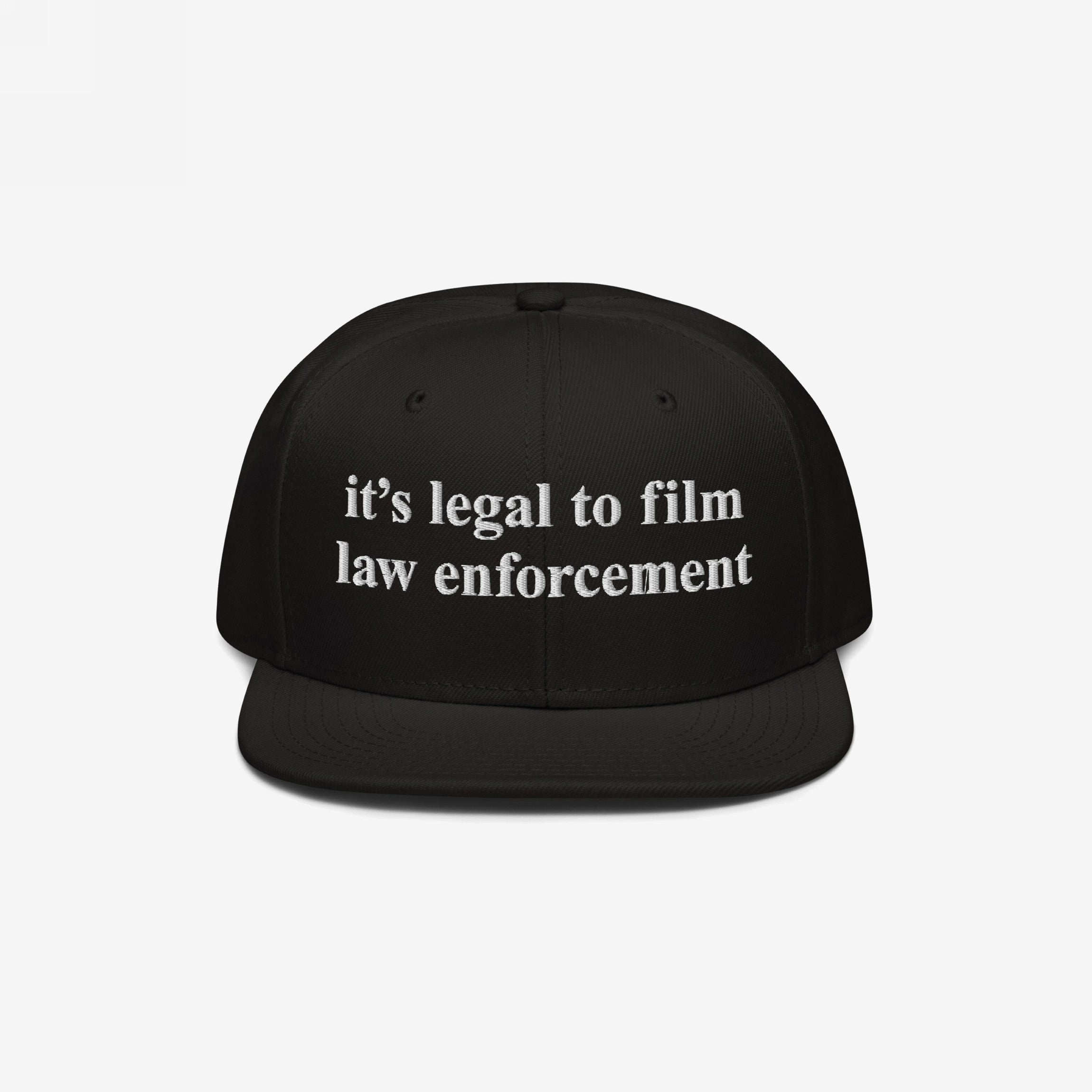Black Film The Police Hat with flat brim, featuring white embroidered text it’s legal to film law enforcement. Designed for those advocating police accountability and knowing your rights.