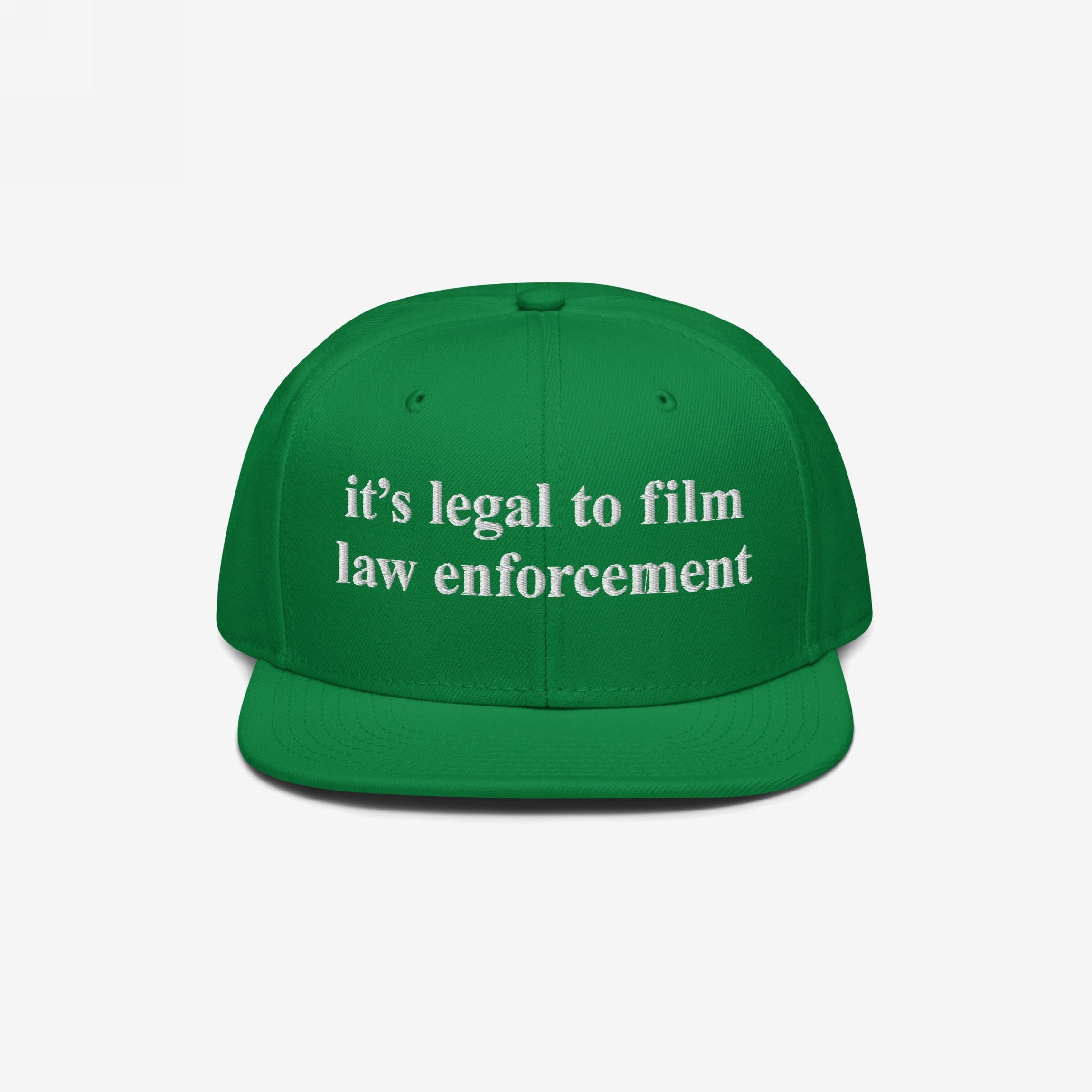 Film The Police Hat featuring bold white embroidered text, it’s legal to film law enforcement, on a green flat-brimmed cap, promoting police accountability and awareness of your rights.