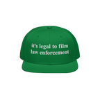 Film The Police Hat featuring bold white embroidered text, it’s legal to film law enforcement, on a green flat-brimmed cap,