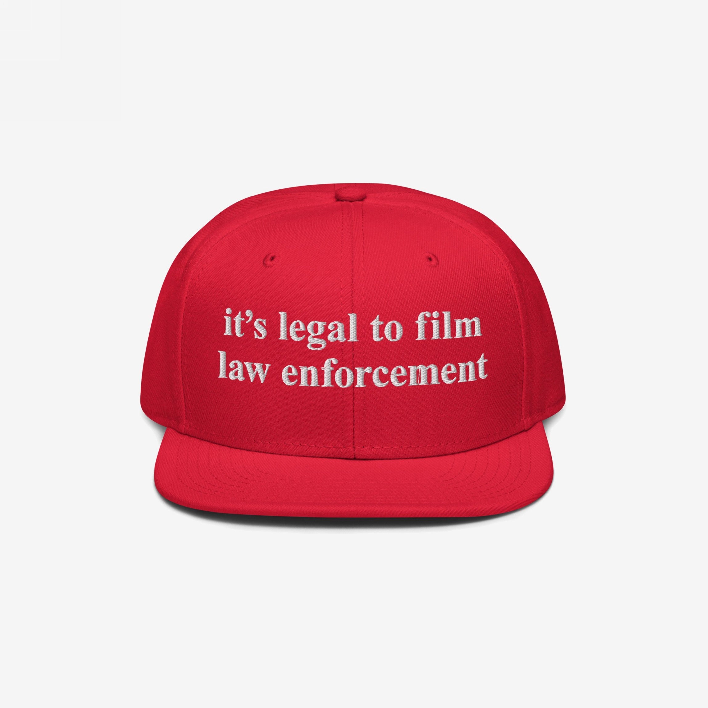 Film The Police Hat with a bright red, flat-brimmed design features white embroidered text stating it’s legal to film law enforcement, emphasizing police accountability and rights awareness.