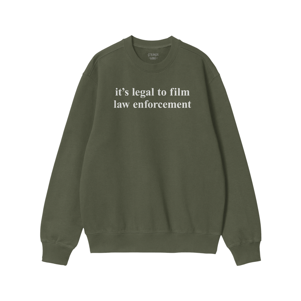 The Film The Police Crewneck Sweatshirt features white text declaring it's legal to film law enforcement on an olive-green ba
