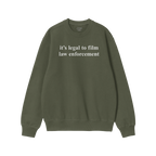 The Film The Police Crewneck Sweatshirt features white text declaring it's legal to film law enforcement on an olive-green ba
