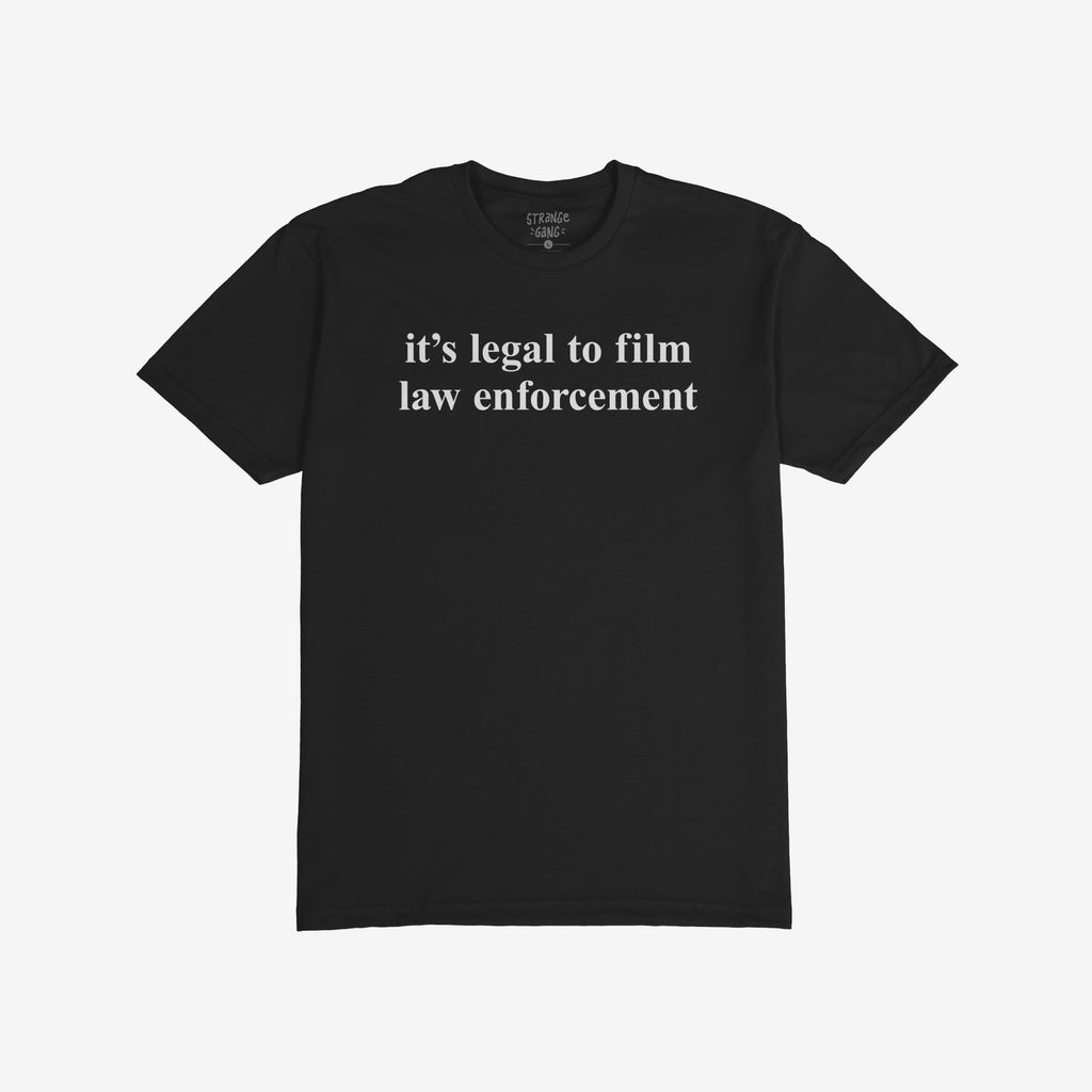 Film The Police T-shirt features the phrase “it’s legal to film law enforcement” in white text on a plain black background, embodying a bold statement with a slightly slim fit design.