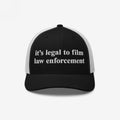 Film The Police Hat: Black-and-white trucker cap with it’s legal to film law enforcement embroidered on the front, symbolizing protest gear for police accountability and rights awareness.