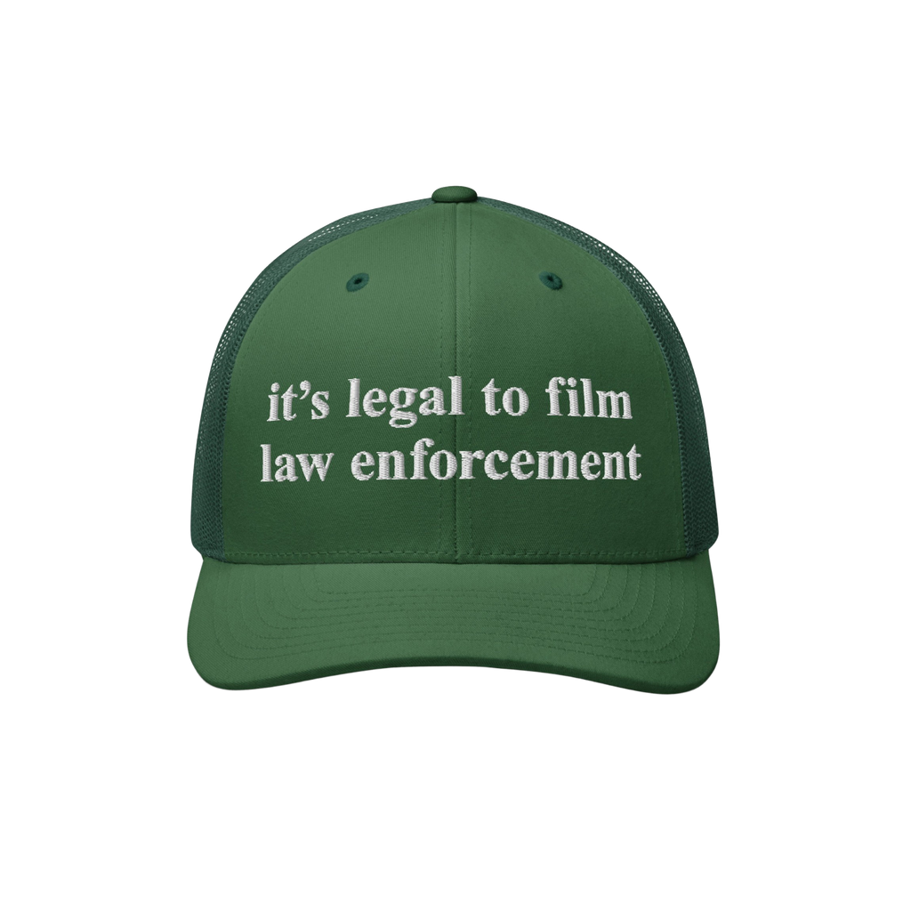 Green trucker-style cap with it's legal to film law enforcement in white embroidery, part of the Film The Police Hat collecti