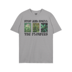 Flowers T-shirt featuring three vertical cannabis images and the slogan “STOP AND SMELL THE FLOWERS” in bold black type, 