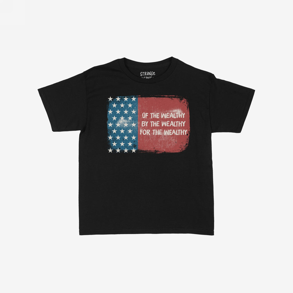 For The Wealthy Women's Baby Tee displays a tattered U.S. flag graphic with the phrase Of the wealthy, by the wealthy, for the wealthy, embodying a bold, socially conscious statement.