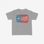 For The Wealthy Women's Baby Tee features a distressed USA flag graphic with a bold statement on a light-gray backdrop, reflecting a sharp, socially conscious message in a fitted Y2K-inspired style.