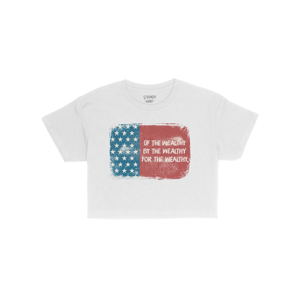 For The Wealthy Women's Baby Tee features a distressed American flag graphic with Of the wealthy, by the wealthy, for the wea