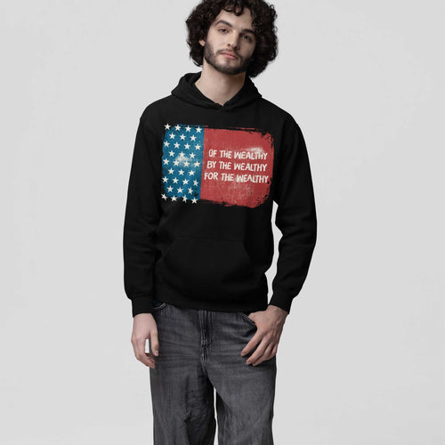 Young man models the For The Wealthy Hoodie, featuring a distressed U.S. flag graphic with protest text, embodying a stance against inequality, perfect for socially-conscious individuals.