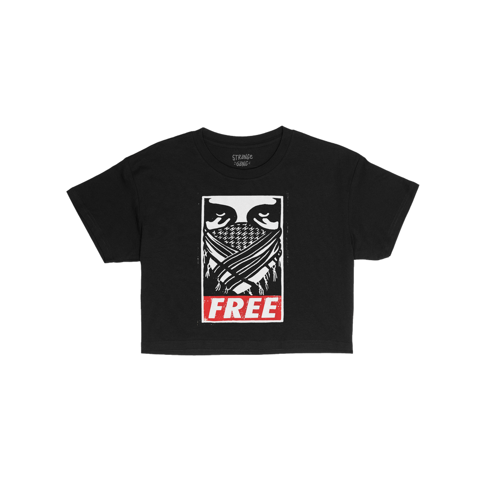 Free Palestine JULZ Women's Baby Tee features a bold graphic of eyes over a patterned scarf, with FREE in red, symbolizing so
