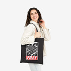 Free Palestine JULZ Tote Bag carried by young woman, features bold graphic of eyes and scarf-like pattern with FREE in red. A statement piece supporting Palestinian freedom, perfect for activists.