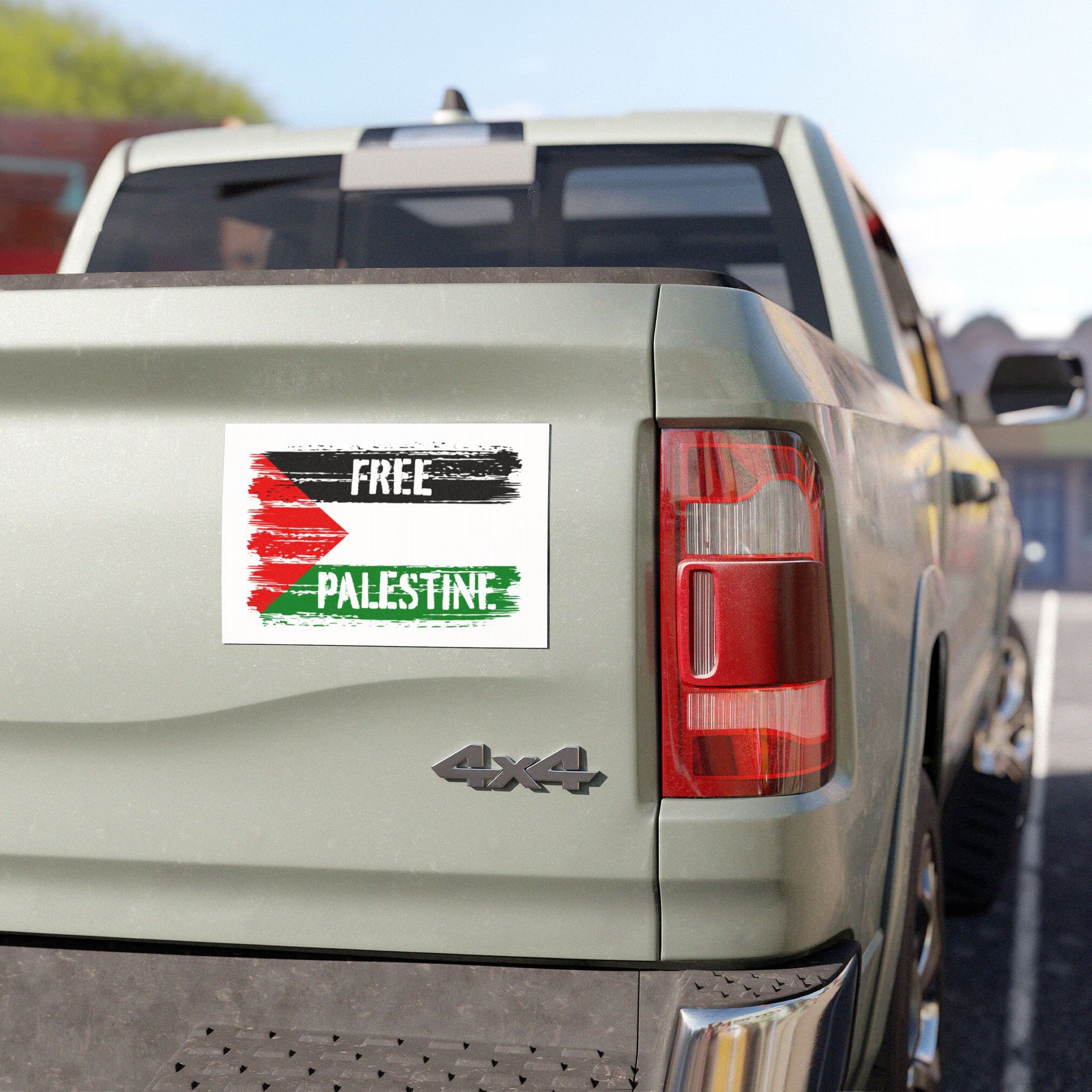 Free Palestine Magnet on a light-colored 4×4 truck's tailgate, showcasing a bold brush-stroke design in red, black, and green, symbolizing solidarity against oppression with all-weather durability.