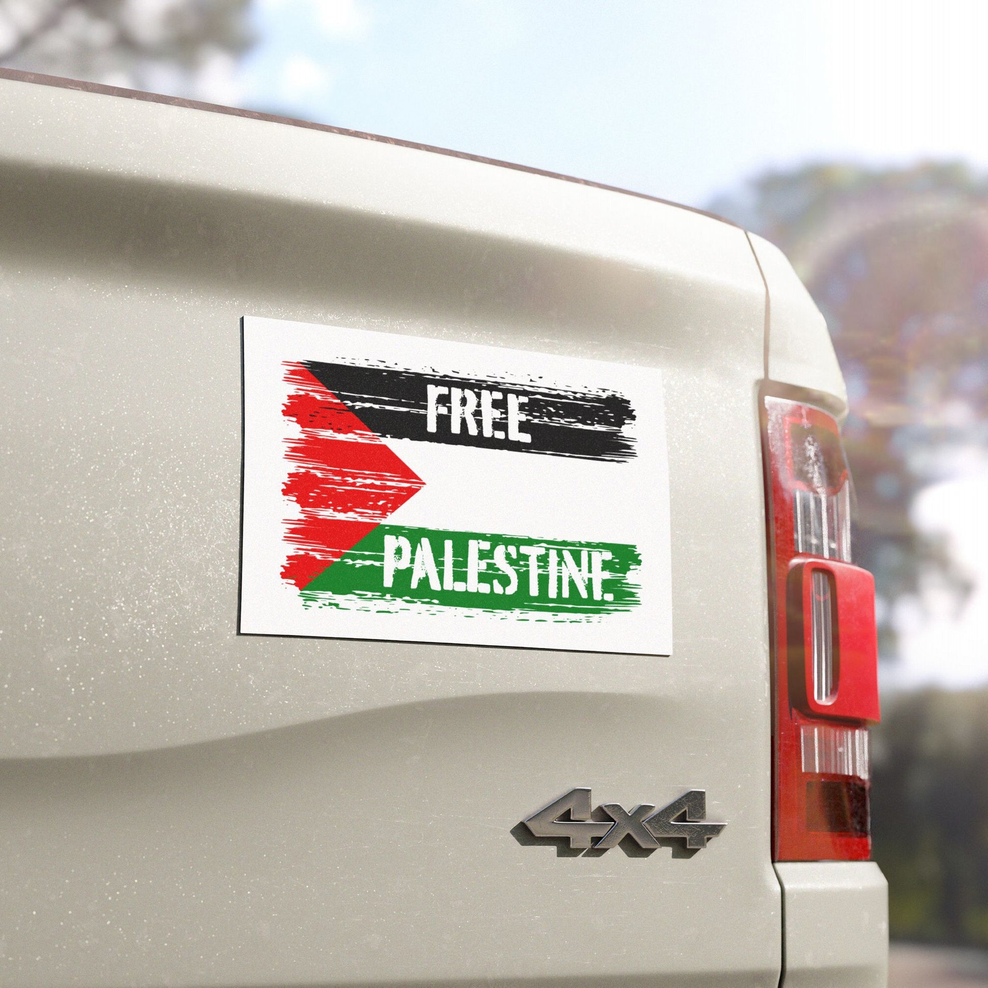 Free Palestine Magnet on a 4x4 pickup truck tailgate, showcasing a message of solidarity with distressed black, red, and green strokes, inspired by the Palestinian flag, advocating justice and liberation.