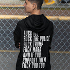 Back view of a person wearing the Fuck 'Em All Back Print Shirt, featuring bold protest text against ICE, police, and Trump. Visible are tattoos behind their ear and neck, and facial piercings.