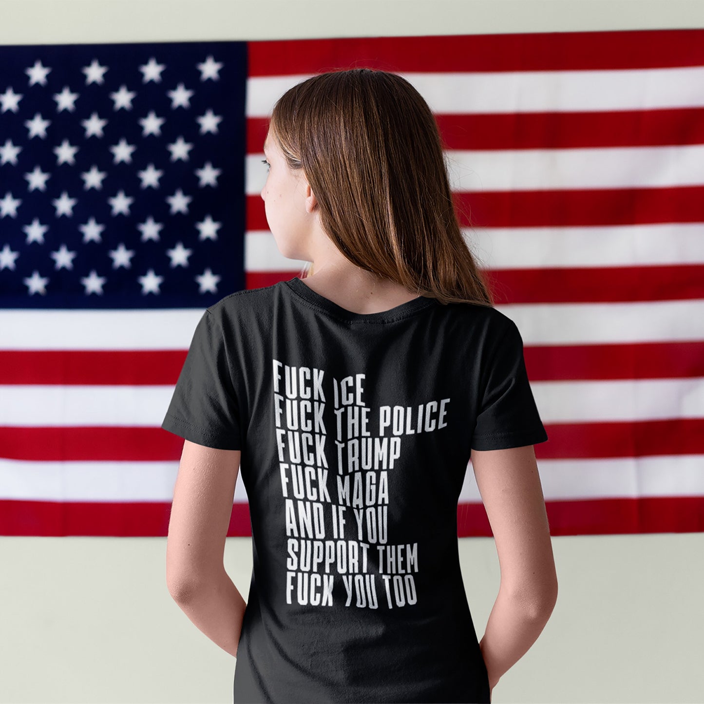 Person facing away, wearing the Fuck 'Em All Back Print T-shirt with bold anti-authoritarian statements on the back, embodying protest spirit and defiance against fascism and inequality.