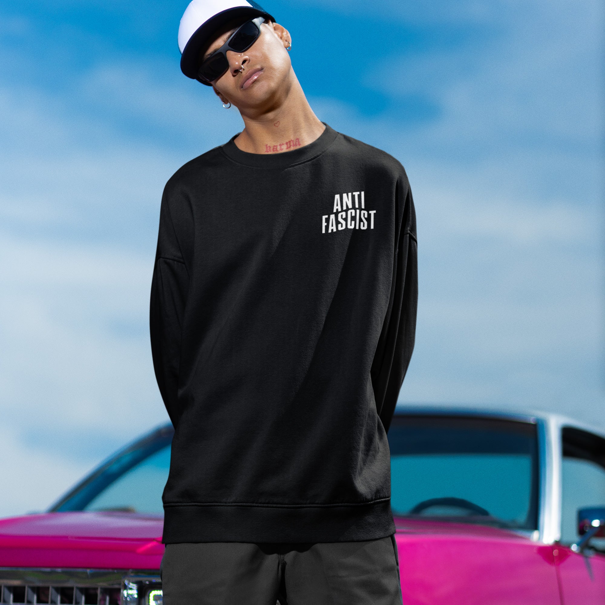 Young person in a Fuck 'Em All Back Print Shirt, featuring ANTI FASCIST on the front, epitomizing protest-ready style with bold messaging, aligning with anti-fascism and equality advocacy.