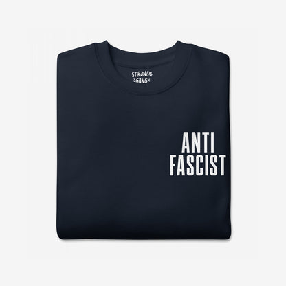 Fuck 'Em All Back Print Hoodie & Sweatshirt folded, featuring bold ANTI FASCIST text on the front lower-right, embodying a clear stance against fascism and oppression.