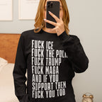 Person taking a mirror selfie wearing the Fuck 'Em All Shirt, featuring bold, anti-fascist statements in white text on a black long-sleeve. Unisex, ethically printed, and protest-ready.