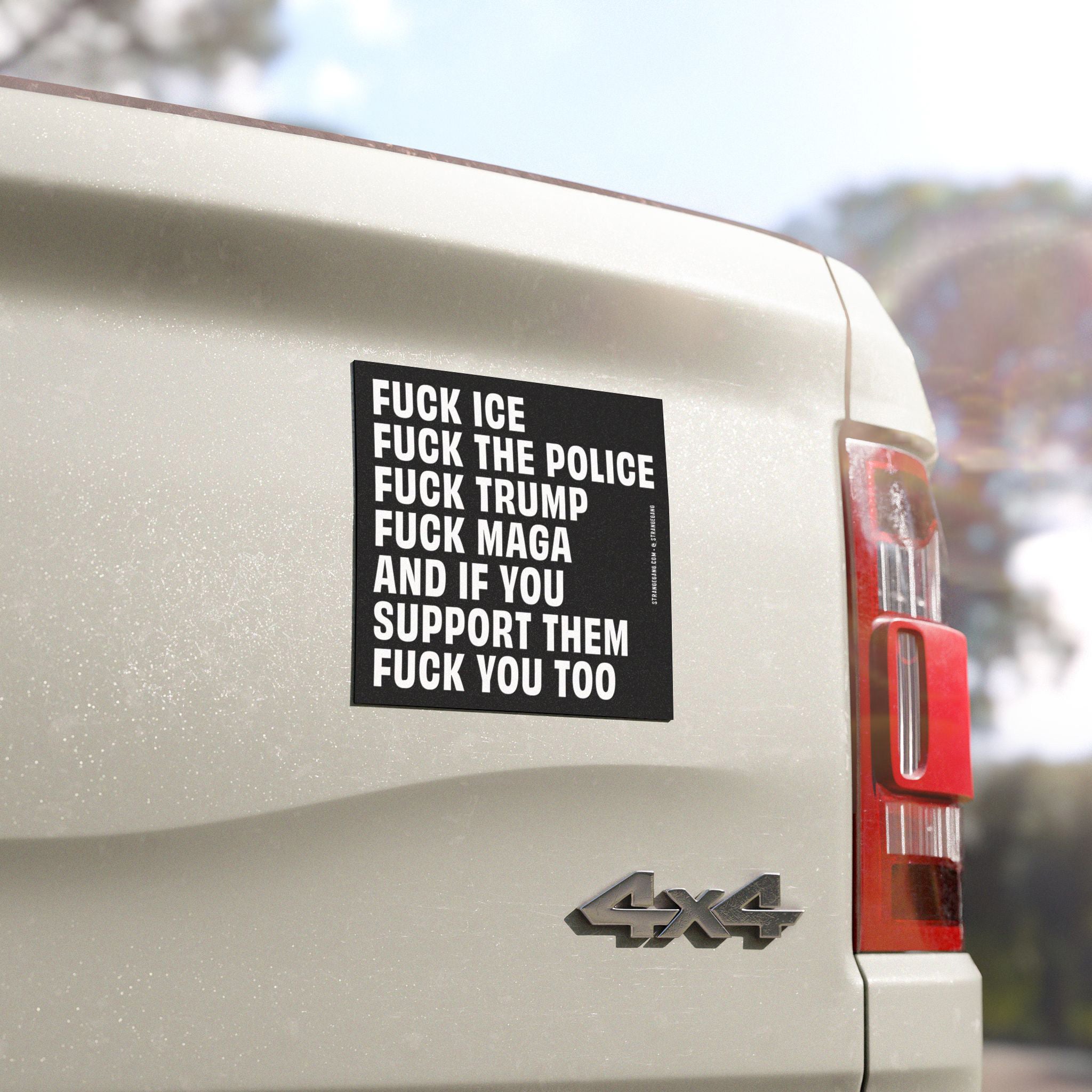 The rear corner of a white 4x4 pickup truck displaying a bold Fuck 'Em All sticker with anti-fascist and ACAB messages, capturing defiant sentiment against ICE, police, Trump, and MAGA supporters.