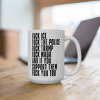 The Fuck 'Em All Mug, a white ceramic mug with bold black text, displaying anti-fascist messages, sits on a wooden surface. Ideal for expressing dissent and supporting equality.