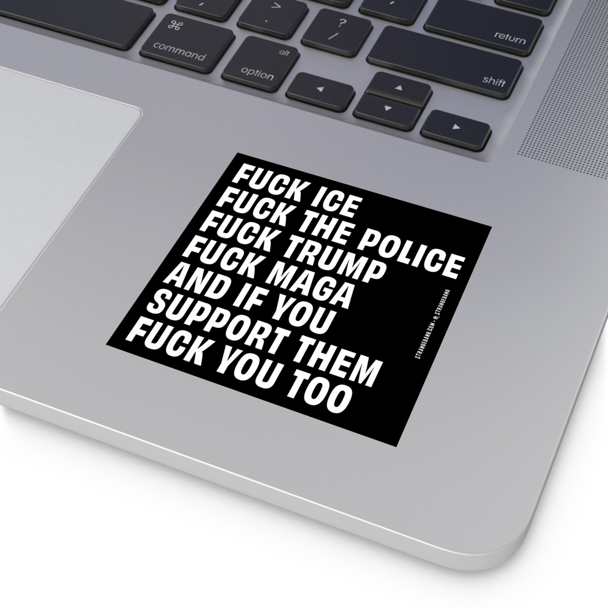 Corner of a silver-gray laptop with the Fuck 'Em All sticker, showcasing bold anti-fascist and ACAB messages, emphasizing defiance and resistance against oppressive systems. Ideal for diverse surfaces.