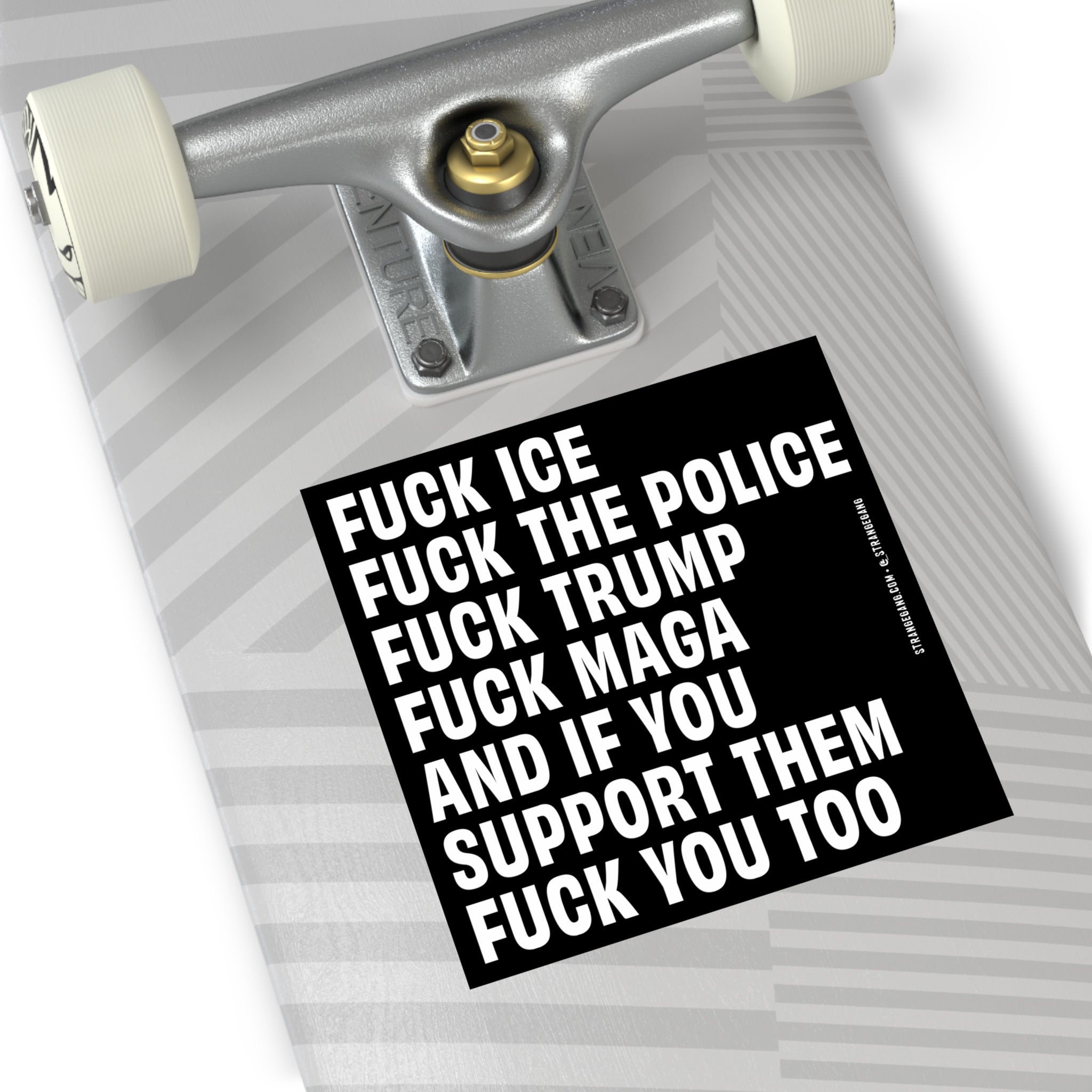 ‘Fuck 'Em All’ Sticker & Magnet on skateboard tail, featuring bold anti-fascist, anti-MAGA message in white text on black. Durable vinyl, ideal for defiant expression on personal items.