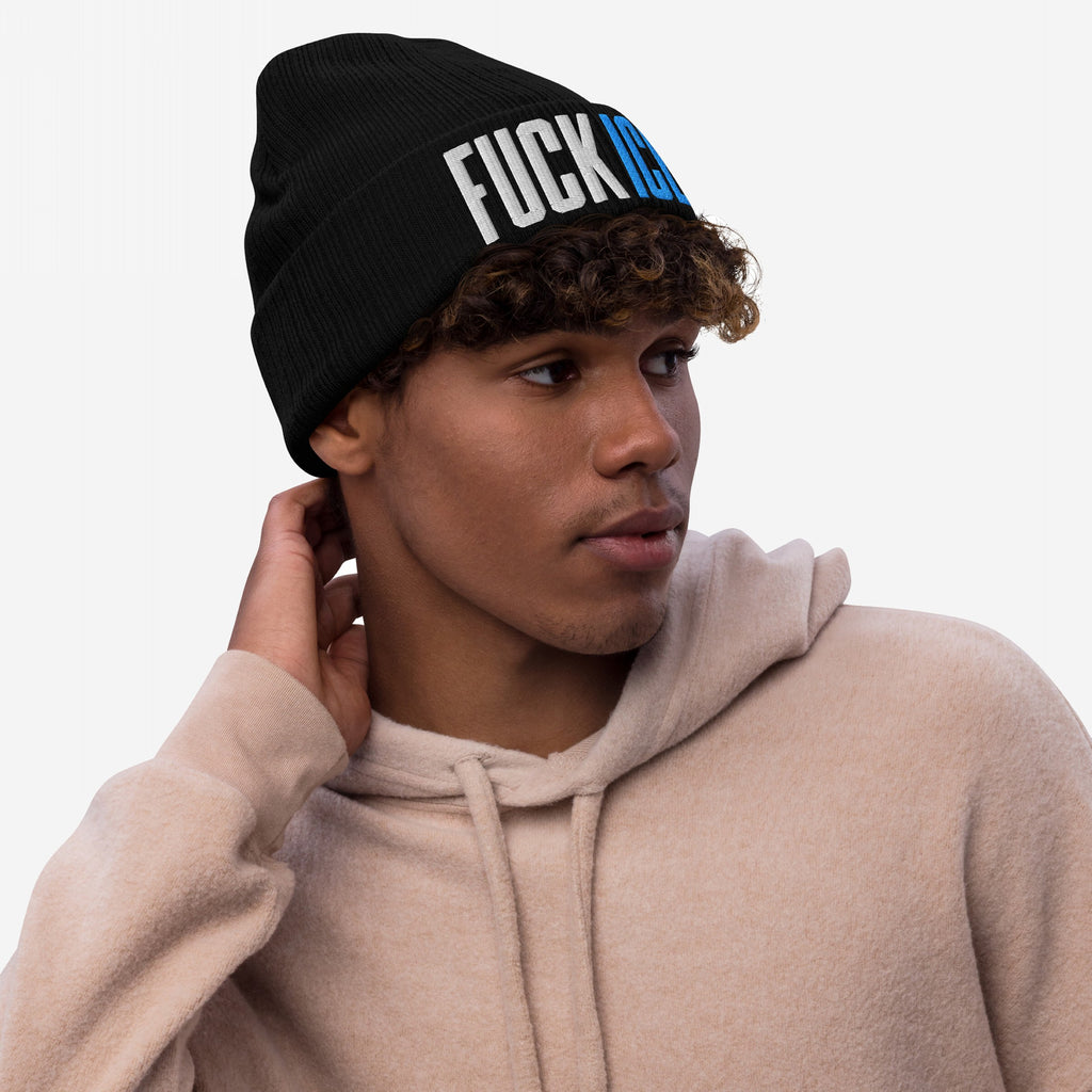 Young man wearing a FUCK ICE Hat, a black knit beanie with bold 3D puff embroidery, embodying strong anti-establishment values. Perfect for standing up against injustice and making a statement.