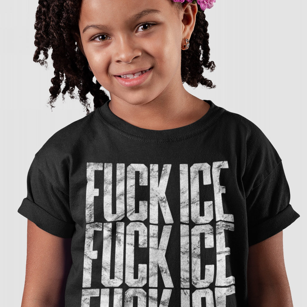 Young girl with dark curly hair wearing a black FUCK ICE T-shirt, featuring a bold, distressed print repeated thrice, smiling confidently against a light background, embodying a strong, unapologetic message.