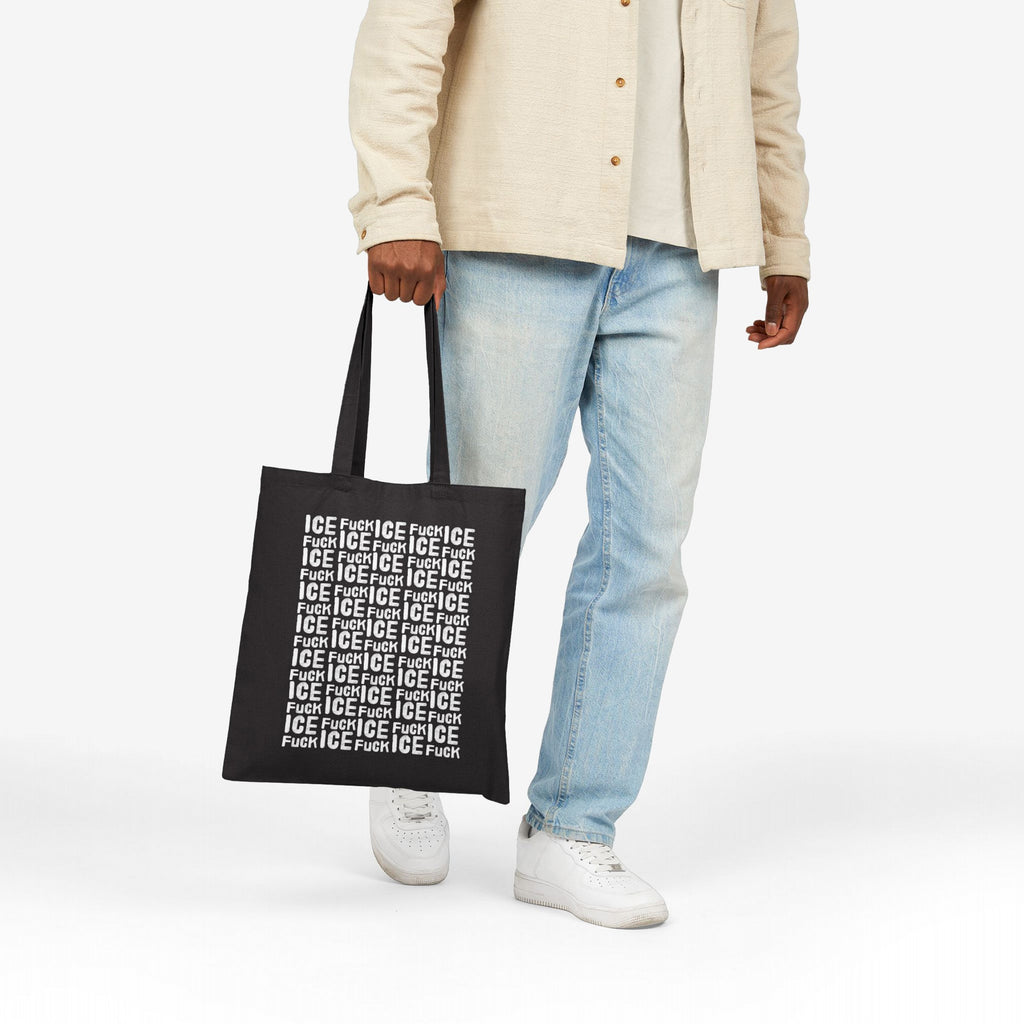 Fuck ICE Pattern Tote Bag held by a casually dressed person, showcasing its bold white text design against black canvas, symbolizing a stance against ICE, supporting equality and human rights advocacy.