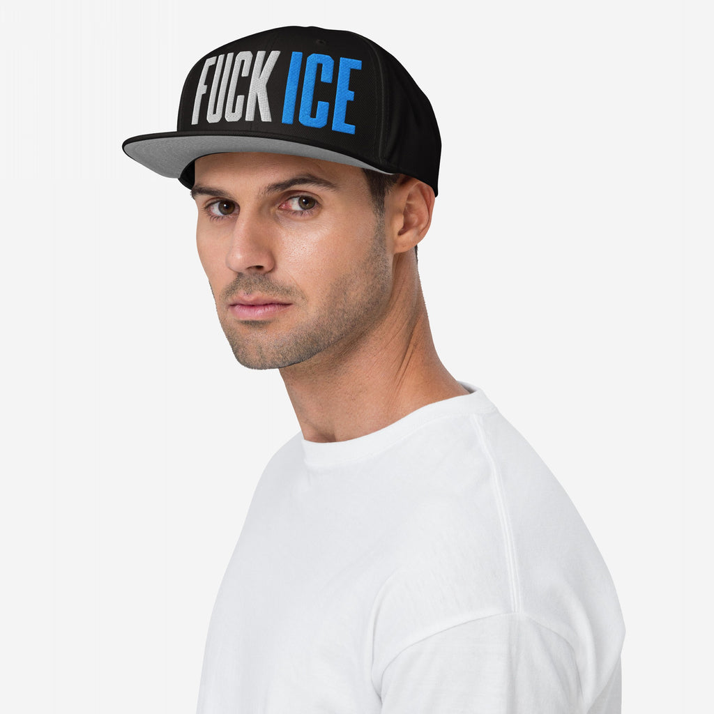 Young man wearing a FUCK ICE hat in bold 3D embroidery, representing a strong stance against injustice. The black flat-brim cap adds a powerful voice to any activist wardrobe.