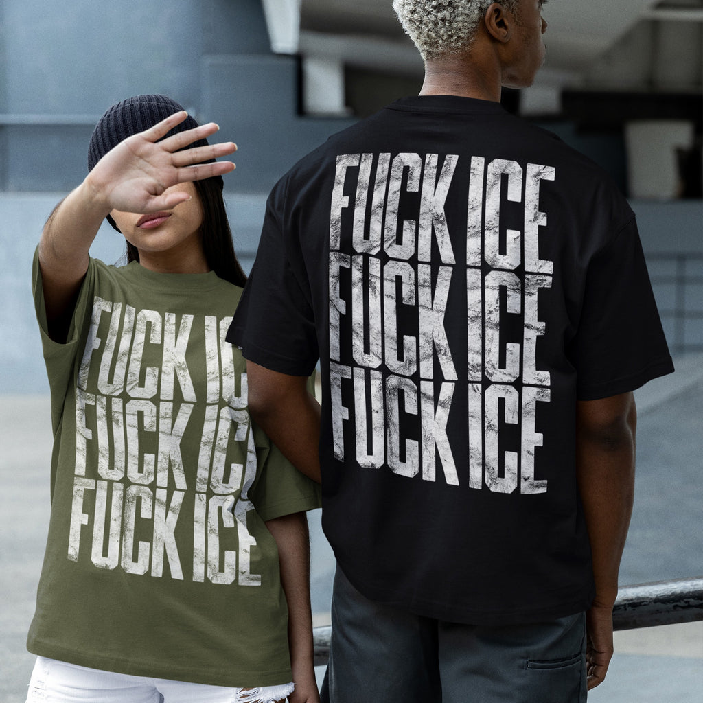 Two people in an urban plaza wear oversized FUCK ICE T-shirts, one olive-green, one black, each with distressed lettering, embodying the bold, activist spirit of the Fuck ICE T-shirt collection.