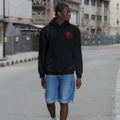 Fucks To Give Hoodie on young person strolling a city street. Black hoodie with small red graphic front, bold sarcastic message on back. Paired with denim shorts, embodying unapologetic disengagement.