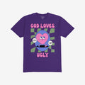 God Loves Ugly T-shirt featuring a cartoonish pink heart character with affirmations, embodying a bold, inclusive message of self-worth, surrounded by vintage comic book style on a purple tee.