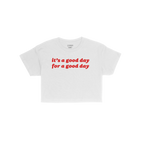 Good Day Women's Baby Tee features bold red text promoting positivity. This cropped, short-sleeve crew-neck T-shirt embodies 