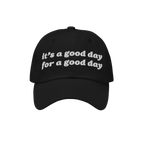 The Good Day Hat features chunky white embroidery stating it’s a good day for a good day. This black baseball cap promotes 