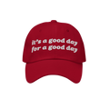 Red Good Day Hat with white embroidered text: it’s a good day for a good day. Perfect for spreading positivity and supporti