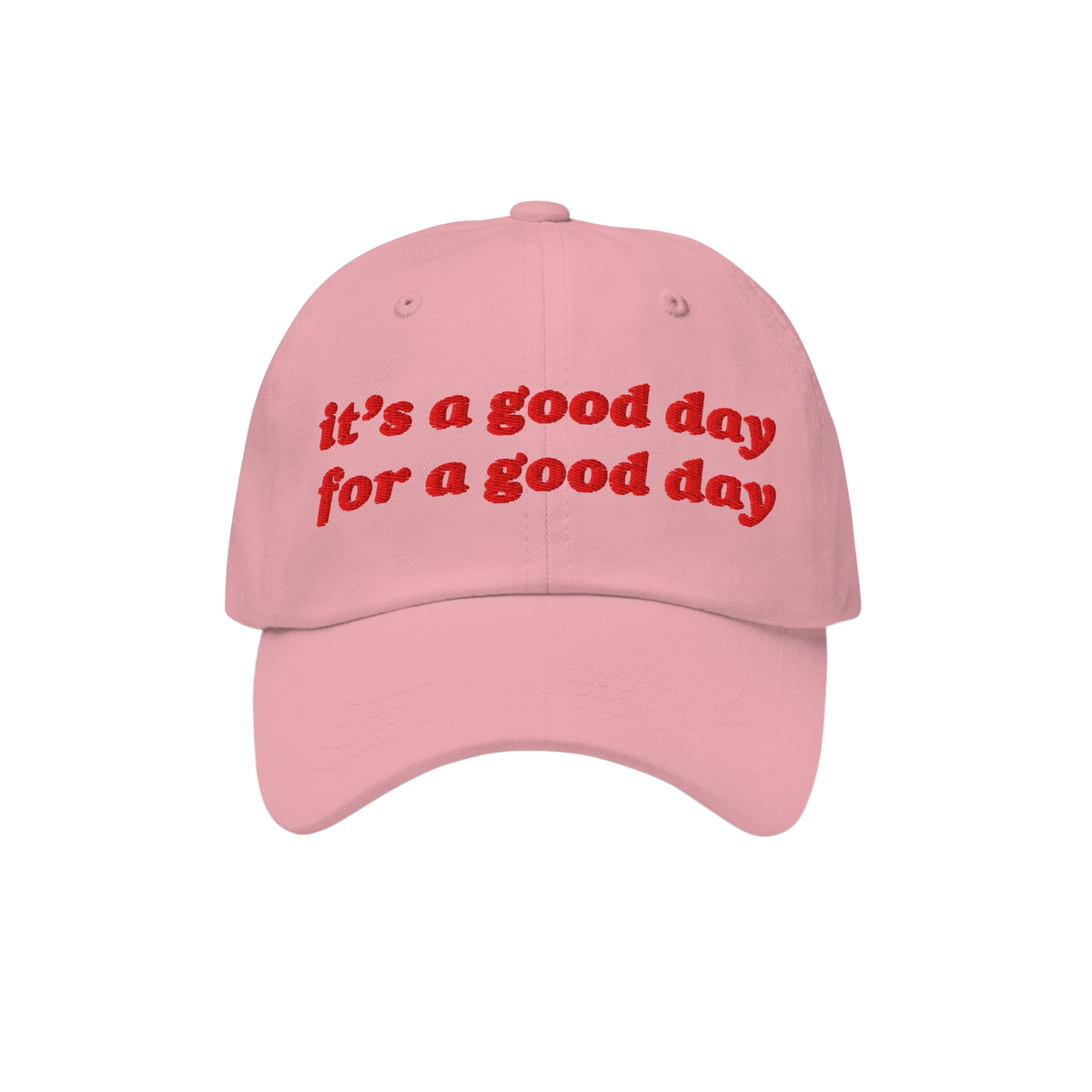 The Good Day Hat features uplifting red embroidery stating, “it’s a good day for a good day,” on a light pink baseball 