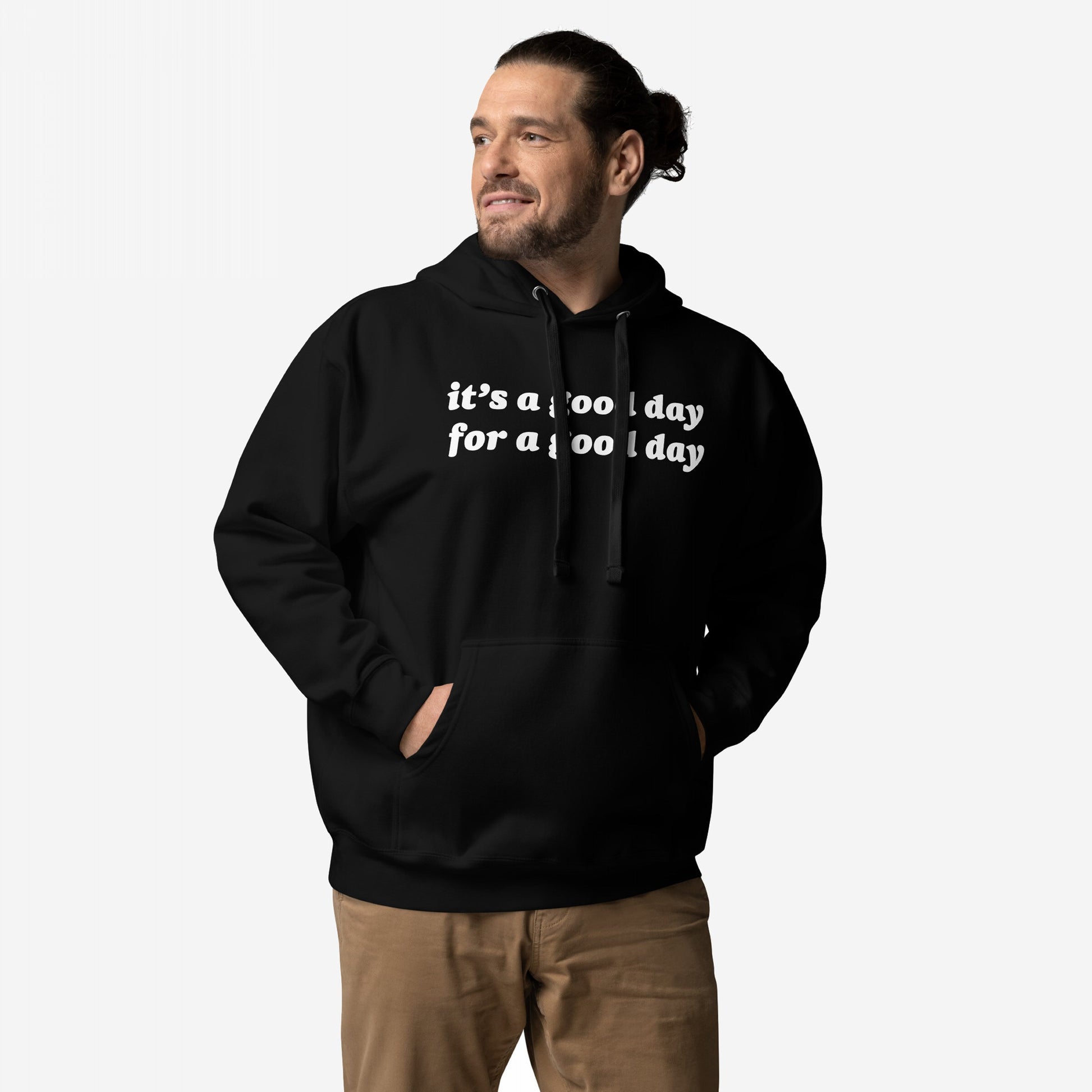Person wearing the Good Day Hoodie & Sweatshirt, featuring it’s a good day for a good day text. The black pullover has a kangaroo pocket, paired with tan pants, embodying optimism and comfort.
