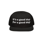 Black snapback cap with white embroidery reading: it’s a good day for a good day. The Good Day Hat spreads positivity, idea