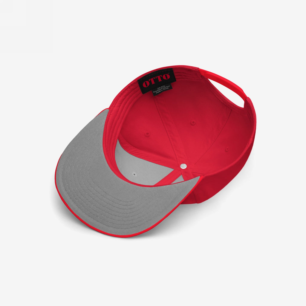 The Good Day Hat, an unstructured six-panel cap, showcases a bright red fabric with a light gray underside brim, featuring an OTTO label and an uplifting embroidered phrase on its exterior.