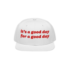 White flat-brim Good Day Hat with red embroidered text: “it’s a good day for a good day,” embodying positivity. Ideal f