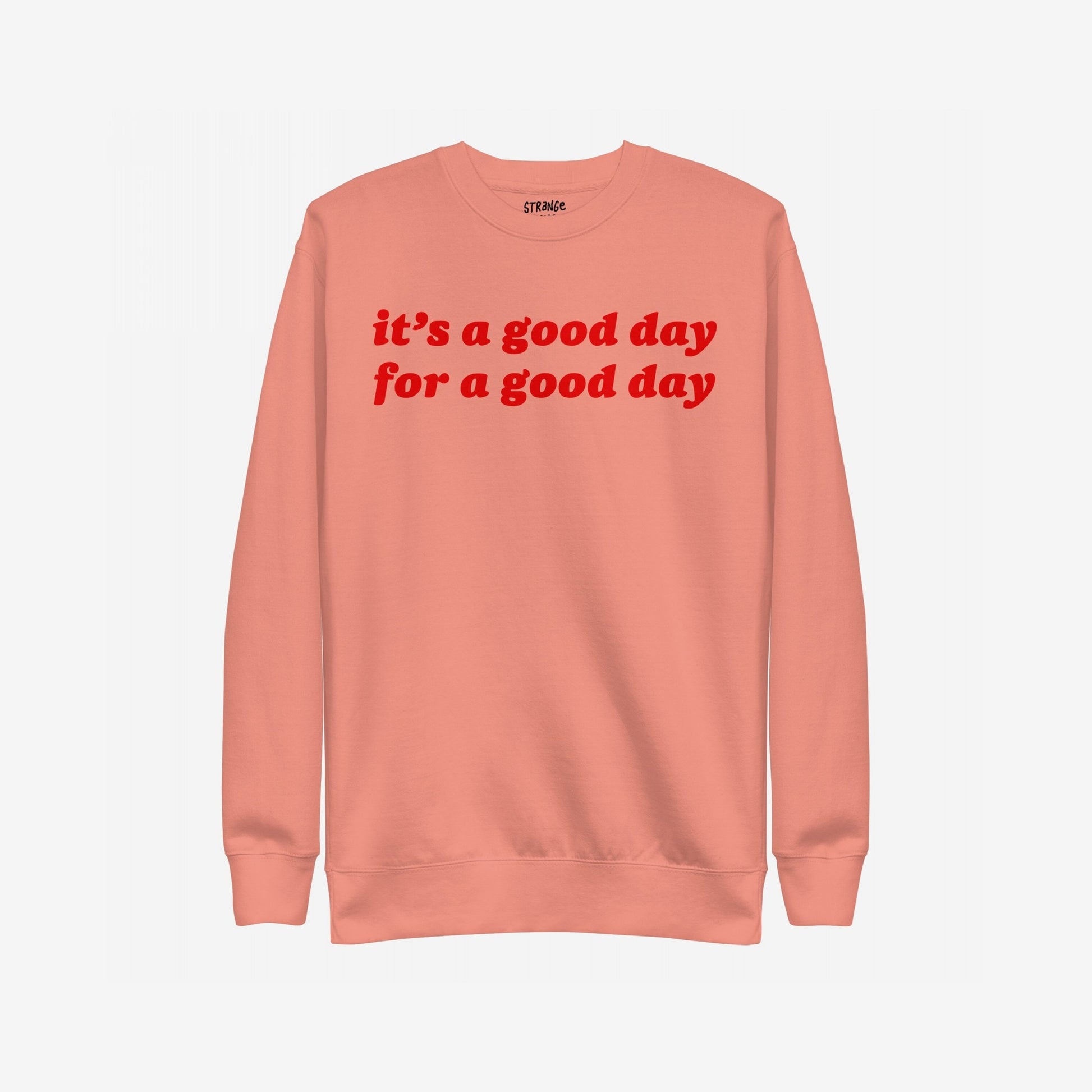 Good Day Hoodie & Sweatshirt features a soft-peach crewneck with bold red lettering, “it’s a good day for a good day,” offering comfort and positivity in a retro style.