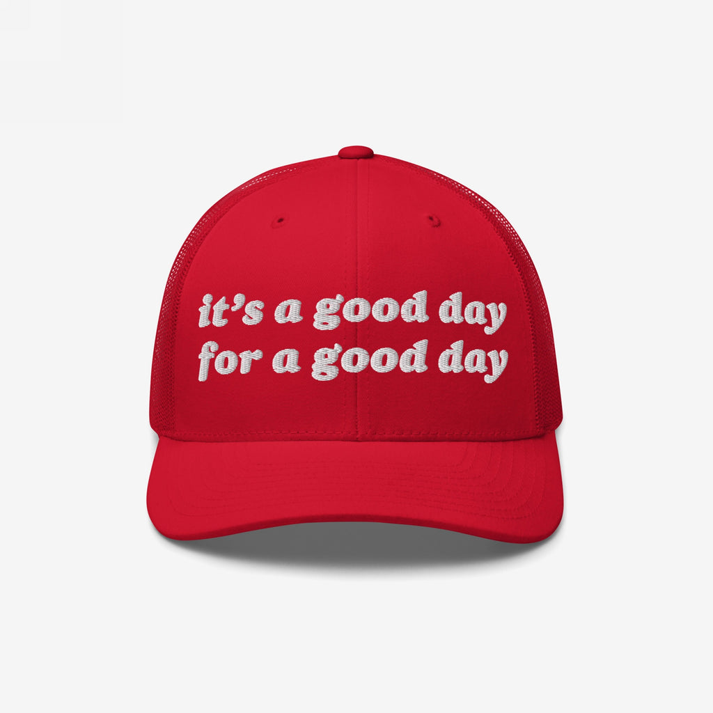 Good Day Hat: A red trucker-style cap with white embroidery that reads it's a good day for a good day, featuring a curved bill and mesh back, embodying positivity and retro flair.