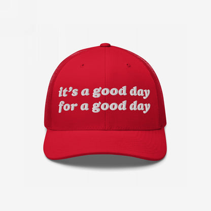 Bright red trucker-style cap with “It’s a Good Day for a Good Day” in white embroidery, embodying optimism and activism. Ideal for mental health advocates and positivity promoters.