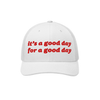 Good Day Hat: A white trucker-style cap with red embroidered text, it’s a good day for a good day, mesh back, and curved br