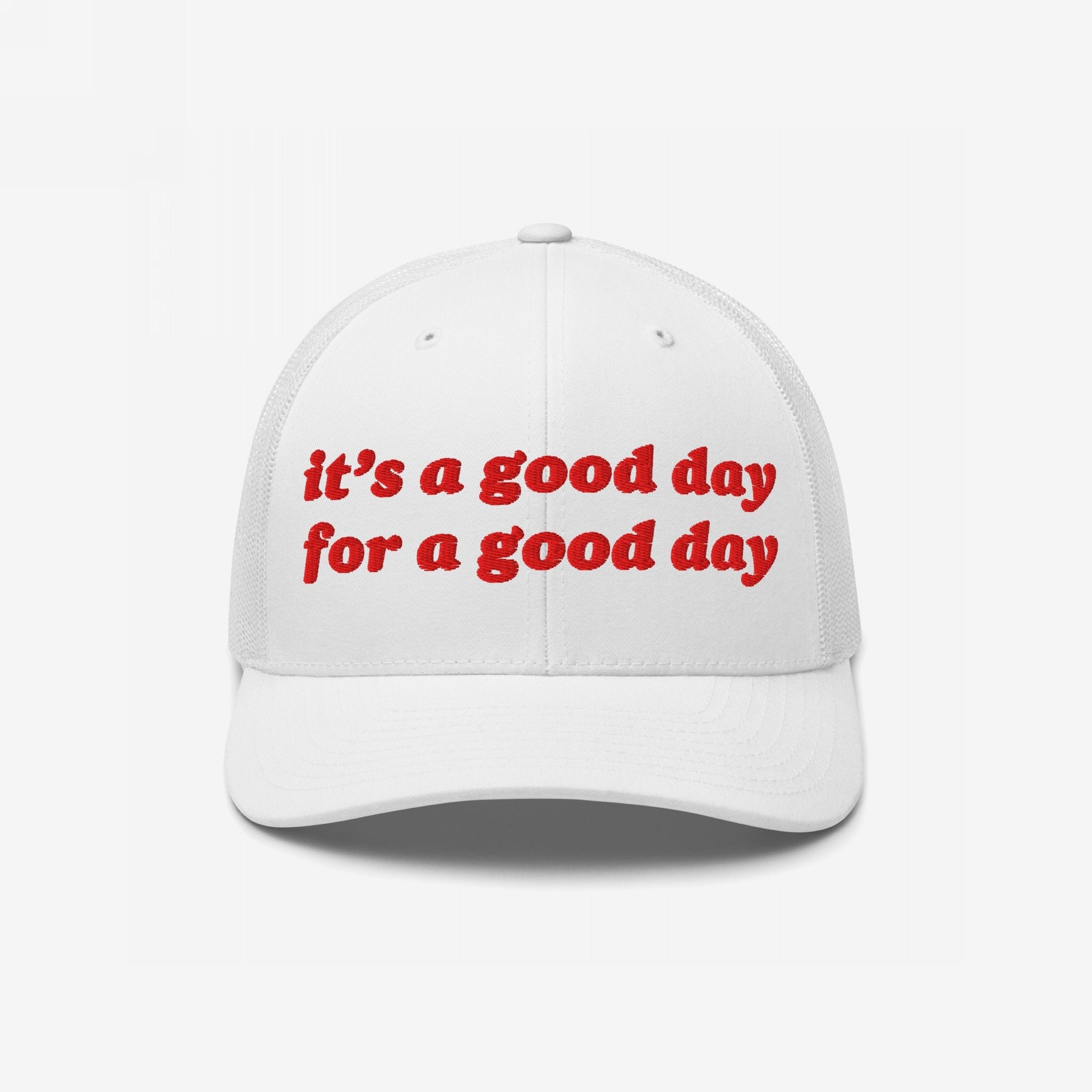 Good Day Hat: white trucker-style cap with red embroidered uplifting text, curved brim, and mesh back. Ideal for promoting positive vibes and supporting mental health advocacy.