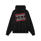 Black hoodie titled Governed By Criminals features a distressed red-and-white warning-tape style graphic and warning triangle